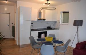 a kitchen and dining room with a table and chairs at Apartman Oneum in Omiš