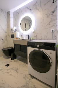 a bathroom with a washing machine and a sink at Casa de Castro - City Apartments in Thessaloniki