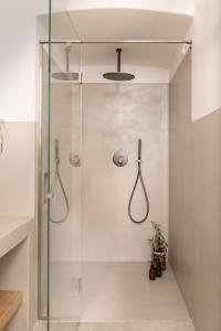 a shower with a glass door in a bathroom at Masseria Auraterrae in Polignano a Mare +37 photos