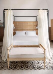 Masseria Auraterrae في بولينيانو آ ماري: غرفة نوم بسرير مع اطار سرير خشبي