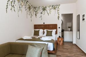 a bedroom with a large bed and a couch at Sabbia Mini Pool Suites in Preveza