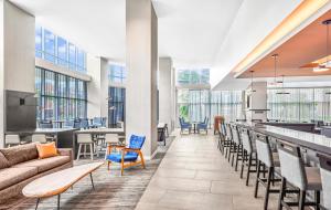 a lobby with a couch and chairs and a bar at Hyatt House Houston Medical Center in Houston