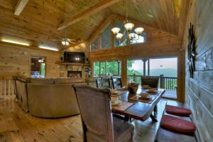 a dining room and living room in a log home at Hummingbird Haven in Chatsworth