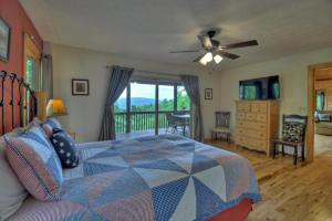 a bedroom with a bed with a ceiling fan and a balcony at Hummingbird Haven in Chatsworth