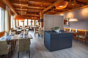 a restaurant with tables and chairs in a room at Hotel & Restaurant Chärnsmatt in Rothenburg