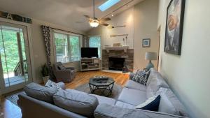 a living room with a couch and a tv at Just Beachy in Union Pier