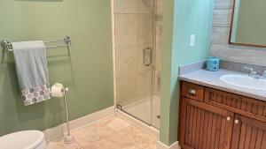 a bathroom with a shower and a toilet and a sink at Just Beachy in Union Pier +21 photos
