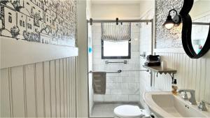 a bathroom with a toilet and a sink and a shower at Lake Perch in Lakeside +38 photos