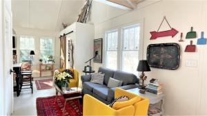 a living room with a blue couch and yellow chairs at Lake Perch in Lakeside