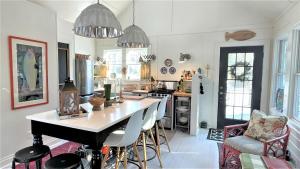 a kitchen with a table and some chairs in it at Lake Perch in Lakeside