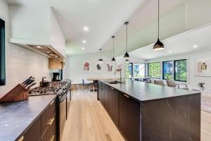 an open kitchen with a large island with a counter top at Springfield Beach House in Union Pier