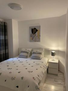 Кровать или кровати в номере Jardines Apartment