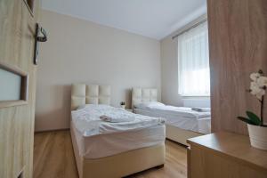 Кровать или кровати в номере Apartamenty Kcyńska