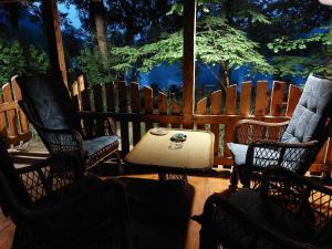 a group of chairs and a table in a porch at FortUNA Holiday Home in Bihać