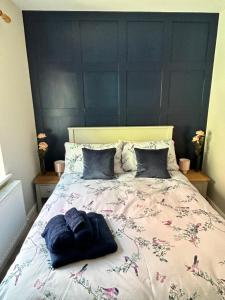 a bedroom with a large bed with two pillows at Blue Haven in Moville