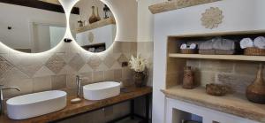 a bathroom with two sinks and a mirror at CasaSignorina in Leuca
