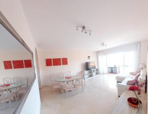 a white living room with a table and a couch at Luxurious Apartment 2 Bedroom 2 Bathroom Near Beach in Málaga