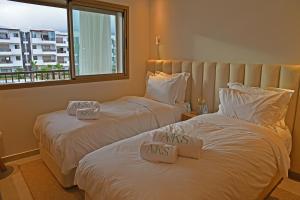מיטה או מיטות בחדר ב-AKS Home appart 1 - CABONEGRO