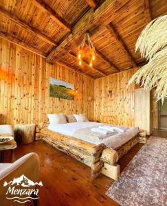 a bedroom with a large bed in a wooden room at Menzara Hotel & Restaurant in Sapanca