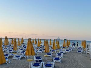 a bunch of chairs and umbrellas on a beach at FRONTE MARE in Palermo