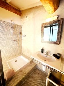a bathroom with a tub and a sink and a shower at Magnifique Loft - Piscine - Tennis - Babyfoot in Nîmes