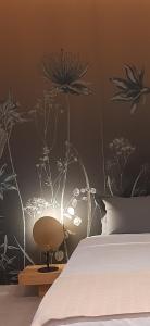 a bedroom with a bed with a flower mural on the wall at Sroom Apartment in Mesolongion