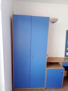 a blue cabinet in a room with a desk at Villa Poliana in Sveti Vlas