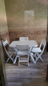 a white table and two white chairs next to a table at Villa de luxe residence tamaris marina 6 piscines jardin parking in Saidia 