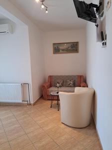 a living room with a couch and a table at Pansion Dovodja in Vodice