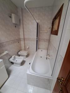 a bathroom with a shower and a toilet and a sink at Stanze Del Corso in San Marco dei Cavoti