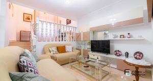 a living room with a couch and a tv at Pedro Jover 9 R&R in Almería