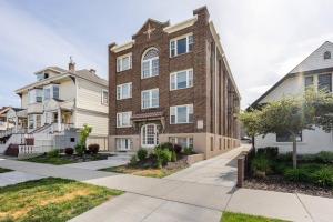 ein Backsteinapartment-Gebäude mit Bürgersteig in der Unterkunft Lady Madonna Sage Flat in Salt Lake City