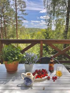 een tafel met een fruitschaal en een kopje koffie bij Anika dom w lesie nad jeziorem Słupinko in Dziemiany