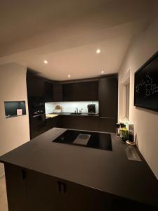 a kitchen with black cabinets and a counter top at Remarkable 2-Bed Apartment in Tromso in Tromsø