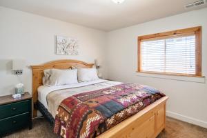 a bedroom with a large bed and a window at Four resorts within 20 minutes from your door step!! in Cottonwood Heights