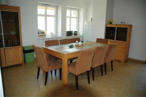 a kitchen with a dining room table and chairs at Eko Marina Mikolajki in Mikołajki