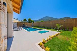 a backyard with a swimming pool and a fence at Fethiye Villa Ka Exclusive 1 in Fethiye