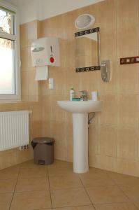 a bathroom with a sink and a mirror at Eko Marina Mikolajki in Mikołajki