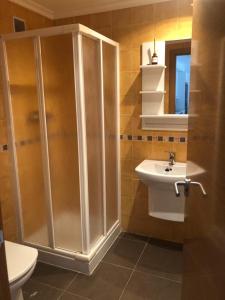 uma casa de banho com um chuveiro e um lavatório. em Apartamento Boutique Arquera Golf II -Llanes em Llanes