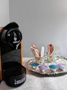 un tavolo con macchinetta del caffè e un vassoio con tazze di Casa Elisa affittacamere ad Armeno