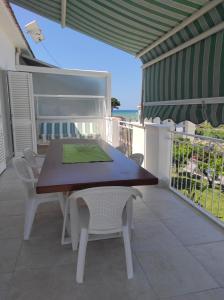 a table and chairs on a patio with the ocean at Deluxe Romantic Suite in San Menaio