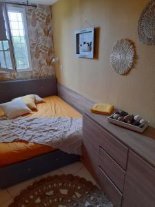 a small bedroom with a bed and a dresser at Magic mer in Saint-Raphaël +59 photos