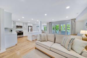 a living room with a couch and a kitchen at Mahalo Cape May Townhomes in Cape May