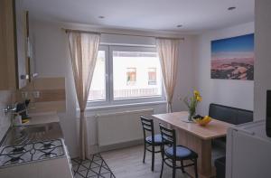 a kitchen with a table and chairs and a window at Desa in Mýto pod Ďumbierom