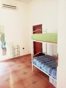 een slaapkamer met 2 stapelbedden en een tegelvloer bij La Casa dell'Artista in Marconia