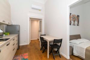 a kitchen with a table and two chairs and a bed at Piccolo Principe in Turin