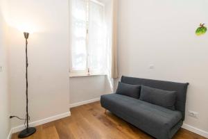 a living room with a couch and a window at Piccolo Principe in Turin