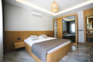 a bedroom with a large bed and a mirror at Maye Residence in Gümbet