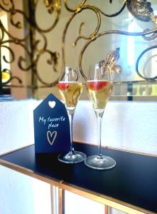 two glasses of wine sitting on a table at Ferienwohnung Lucia in Schiefling am See