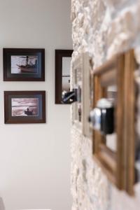 a group of pictures hanging on a wall at Photel Apartments in Crikvenica +46 photos